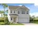 Charming two-story home featuring a stone facade, attached two-car garage, and manicured landscaping at 4201 Brindle Pl, Loganville, GA 30052