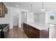 Spacious kitchen island with granite countertops and dark wood cabinetry at 4201 Brindle Pl, Loganville, GA 30052