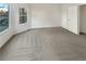 Spacious bedroom with neutral carpet, bright windows, and ample natural light at 4396 Shelley Nw Ln, Lilburn, GA 30047