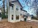 Charming two-story home with light green siding, large windows, and covered front porch at 4396 Shelley Nw Ln, Lilburn, GA 30047