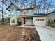 Charming two-story home with light green siding, a front porch, and a one-car garage at 4396 Shelley Nw Ln, Lilburn, GA 30047