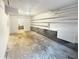 Unfinished garage with storage shelving, concrete floor, and neutral walls at 4396 Shelley Nw Ln, Lilburn, GA 30047