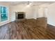 Living room featuring a stone fireplace, wood flooring, a ceiling fan, and large windows at 4396 Shelley Nw Ln, Lilburn, GA 30047