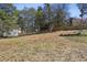 Large backyard with mature trees and a wooden fence, great for outdoor activities and relaxation at 663 Foxcroft Circle Se, Marietta, GA 30067