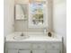 Small bathroom with white cabinets, sink, and a bright window at 663 Foxcroft Circle Se, Marietta, GA 30067