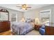 Comfortable bedroom with two windows, a ceiling fan, and warm lighting at 663 Foxcroft Circle Se, Marietta, GA 30067
