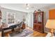 Cozy bedroom featuring a wooden desk, floor lamp, and hardwood floors at 663 Foxcroft Circle Se, Marietta, GA 30067