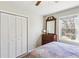 Cozy bedroom featuring a closet, dresser, and sunny window at 663 Foxcroft Circle Se, Marietta, GA 30067