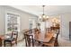 Spacious dining room featuring a large table, chandelier, and windows with natural light at 663 Foxcroft Circle Se, Marietta, GA 30067