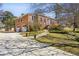 Two-story brick home with a two-car garage, walkway and driveway and landscaped yard at 663 Foxcroft Circle Se, Marietta, GA 30067