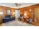 Cozy living room with wood paneling, patterned rug, and comfortable seating at 663 Foxcroft Circle Se, Marietta, GA 30067