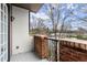 Balcony featuring a red brick railing and black iron supports; providing scenic views of the surrounding neighborhood at 901 Abernathy Ne Rd # 3220, Sandy Springs, GA 30328
