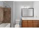 Bathroom featuring a tiled shower and tub, wooden vanity, and a white countertop at 901 Abernathy Ne Rd # 3220, Sandy Springs, GA 30328