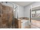 Bright bathroom featuring a tiled shower, separate tub, and natural light at 901 Abernathy Ne Rd # 3220, Sandy Springs, GA 30328