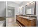 Bathroom with a double sink vanity featuring granite countertops and framed mirrors at 901 Abernathy Ne Rd # 3220, Sandy Springs, GA 30328