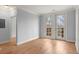 A bright bedroom with hardwood floors and double doors leading to a small balcony at 901 Abernathy Ne Rd # 3220, Sandy Springs, GA 30328