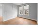 Bright bedroom featuring wood floors, two windows, and neutral walls at 901 Abernathy Ne Rd # 3220, Sandy Springs, GA 30328