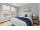 Cozy bedroom with neutral walls, two windows, and hardwood floors with area rug at 901 Abernathy Ne Rd # 3220, Sandy Springs, GA 30328