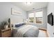 Cozy bedroom with stylish decor, natural light, and mounted TV at 901 Abernathy Ne Rd # 3220, Sandy Springs, GA 30328