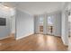 A bright bedroom with hardwood floors and double doors leading to a small balcony at 901 Abernathy Ne Rd # 3220, Sandy Springs, GA 30328