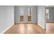 A bright bedroom with hardwood floors and double doors leading to a small balcony at 901 Abernathy Ne Rd # 3220, Sandy Springs, GA 30328