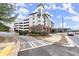 Attractive apartment building exterior with balconies, street views, and adjacent parking garage at 901 Abernathy Ne Rd # 3220, Sandy Springs, GA 30328