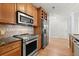 Modern kitchen featuring stainless steel appliances, granite counters, and a wood floor at 901 Abernathy Ne Rd # 3220, Sandy Springs, GA 30328