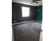 Spacious bedroom featuring dark blue and green walls, ceiling fan, carpeted floor, and a window with blinds at 2383 Baywood Se Dr, Atlanta, GA 30315