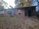 Cozy brick home featuring a charming front porch, an ADT security sign, and an addition under construction at 2383 Baywood Se Dr, Atlanta, GA 30315