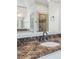 Elegant bathroom featuring a marble countertop, sleek faucet, and a glass-enclosed shower at 2480 Flint Creek Dr, Cumming, GA 30041