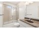 This bathroom features a shower-tub combination with sliding glass door and a vanity with a dark countertop at 2480 Flint Creek Dr, Cumming, GA 30041