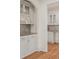 Butler's pantry with granite countertops and white cabinets, providing ample storage and workspace at 2480 Flint Creek Dr, Cumming, GA 30041