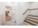 Entryway features a staircase with wood treads, wood handrail, and a clear glass door leading to the kitchen at 2480 Flint Creek Dr, Cumming, GA 30041