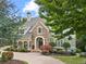 Charming two-story home with stone accents, manicured landscaping, and a welcoming entrance at 2480 Flint Creek Dr, Cumming, GA 30041