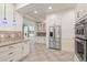 Open kitchen with stainless steel appliances and granite countertops flowing into dining area at 2480 Flint Creek Dr, Cumming, GA 30041