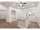 Kitchen island with stone countertops and hardwood floors in a light-filled space at 2480 Flint Creek Dr, Cumming, GA 30041