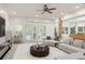 Spacious living room with a ceiling fan, recessed lighting, hardwood floor and white walls, plus a pool table at 2480 Flint Creek Dr, Cumming, GA 30041