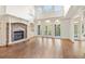 Bright living room features stone fireplace, hardwood floors, and large windows at 2480 Flint Creek Dr, Cumming, GA 30041