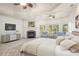 Luxurious main bedroom with fireplace, sitting area, and tray ceilings at 2480 Flint Creek Dr, Cumming, GA 30041