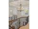 Upper level of home, featuring an ornate chandelier and wrought iron staircase and railing detail at 2480 Flint Creek Dr, Cumming, GA 30041