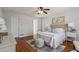 Bright bedroom features hardwood floors, a ceiling fan, and a neutral color palette at 2607 Westchester Se Pkwy, Conyers, GA 30013