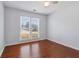 The bedroom has wood floors and a large window to let in light at 2607 Westchester Se Pkwy, Conyers, GA 30013