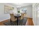 Dining room with hardwood flooring and an elegant chandelier above a dark wood table at 2607 Westchester Se Pkwy, Conyers, GA 30013