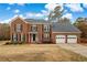 Beautiful two story brick home with a two car garage and manicured lawn at 2607 Westchester Se Pkwy, Conyers, GA 30013