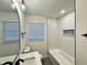 Bright bathroom featuring a modern vanity, tub with white subway tile, and black fixtures at 3147 Bellgreen Way, Decatur, GA 30032