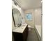 Stylish bathroom with a dark vanity, large mirror, and a shower/tub combo at 3147 Bellgreen Way, Decatur, GA 30032