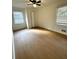 This bedroom features new wood floors, a ceiling fan, and two windows for natural light at 3147 Bellgreen Way, Decatur, GA 30032