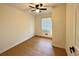 Bright bedroom features neutral walls, a ceiling fan, and beautiful wood-look floors at 3147 Bellgreen Way, Decatur, GA 30032