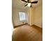 This bedroom features new wood floors, a ceiling fan, and a window for natural light at 3147 Bellgreen Way, Decatur, GA 30032