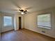 Bedroom features wood floors, a ceiling fan, and two windows for ample natural light at 3147 Bellgreen Way, Decatur, GA 30032